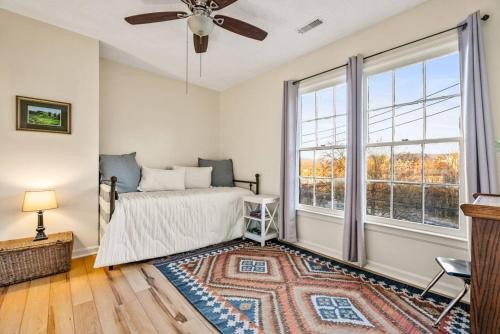 a bedroom with a bed and a large window at Downtown Getaway - Patio Views in Luray