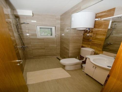a bathroom with a toilet and a sink at Apartments Vesela - Comfort One Bedroom Apartment with Balcony and Sea View in Janjina