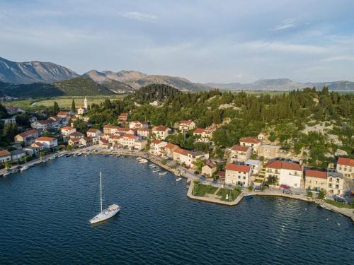 an aerial view of a small town with a boat in the water at Apartments Ema-Comfort Two Bedroom Apartment with Sea View Fancy in Rogotin