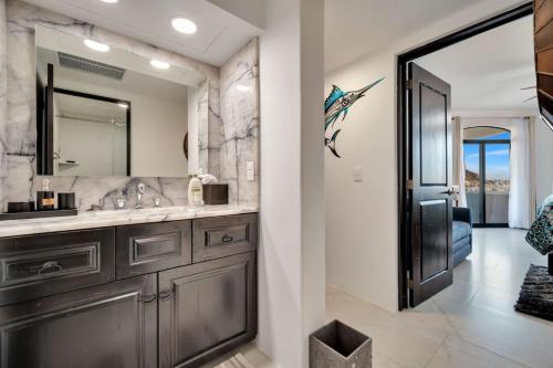 a bathroom with a sink and a mirror at Completely Remodeled 2BD-2BA Plaza Bonita in Cabo San Lucas