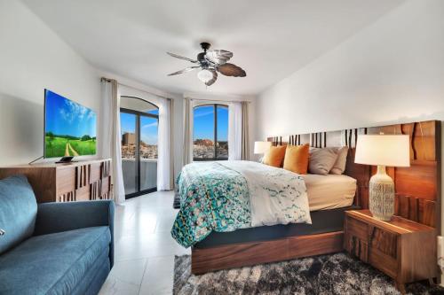a bedroom with a bed and a couch at Completely Remodeled 2BD-2BA Plaza Bonita in Cabo San Lucas