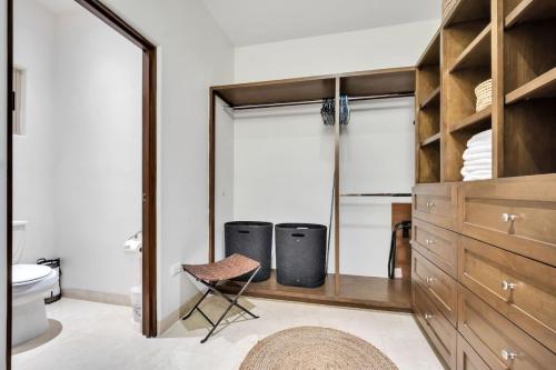 a bathroom with a closet with two trash cans at 2BD-2BA Condo at Ventanas 3B in Cabo San Lucas