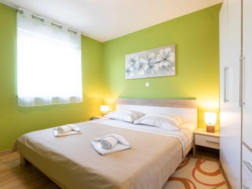 a bedroom with a bed with two towels on it at Apartment Salvagno - Two Bedroom Apartment with Balcony and Sea View in Punat