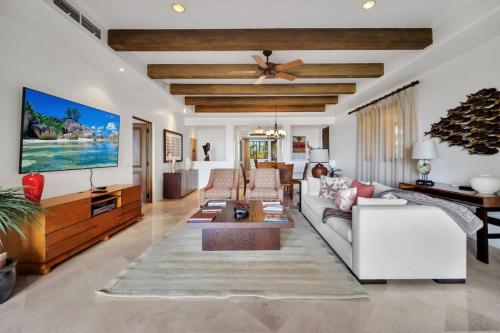 a living room with a couch and a ceiling fan at 2 BD 5-Star Beachfront Paradise in Cabo San Lucas