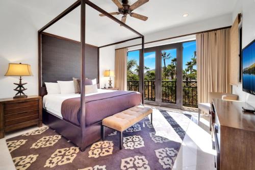 a bedroom with a canopy bed and a balcony at 2 BD 5-Star Beachfront Paradise in Cabo San Lucas