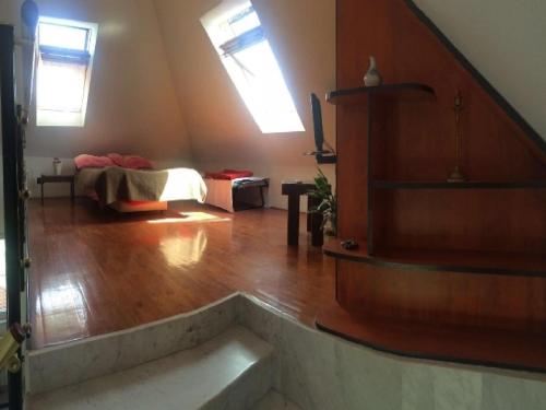 a living room with a bed and a wooden floor at Apartment Simba - Studio Apartment ST in Supetar