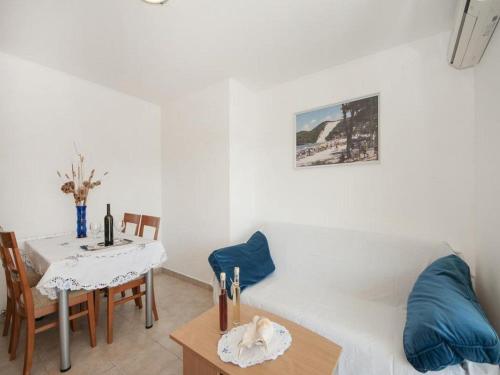 a living room with a table and a dining room at Bertie's Lodge - Two Bedroom Apartment with Terrace and Sea View A1 in Smokvica
