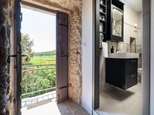 a bathroom with a sink and a large window at Stone House Prapatna-Two Bedroom Holiday Home with Swimming Pool in Smokvica