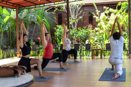 a group of people in a yoga class at The Dukuh Retreat in Tabanan