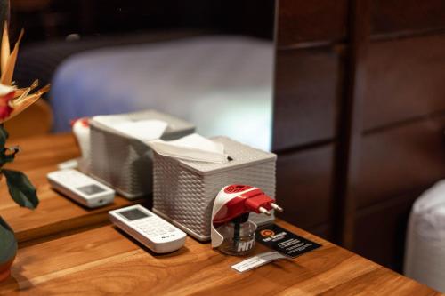 a table with a telephone and a box on it at The Dukuh Retreat in Tabanan