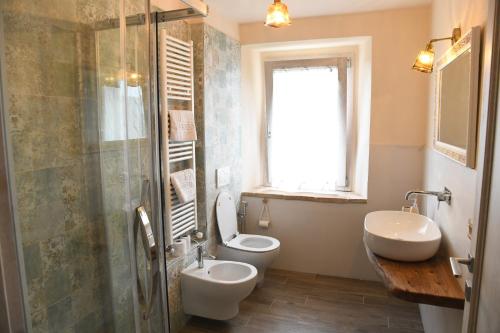 a bathroom with a toilet and a sink and a shower at La Casetta Agriturismo in Santa Sofia