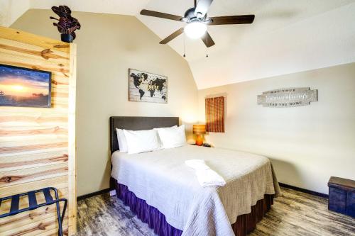 a bedroom with a bed and a ceiling fan at Charming Cabin Near Great Smoky Mountains! in Newport