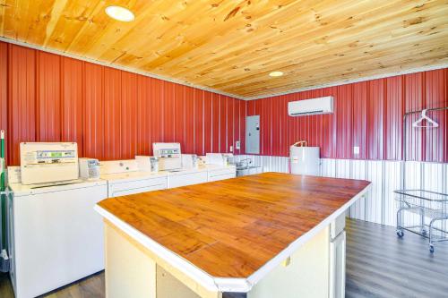 a large kitchen with red walls and a wooden ceiling at Private Hot Tub and Mountain View Newport Home in Newport
