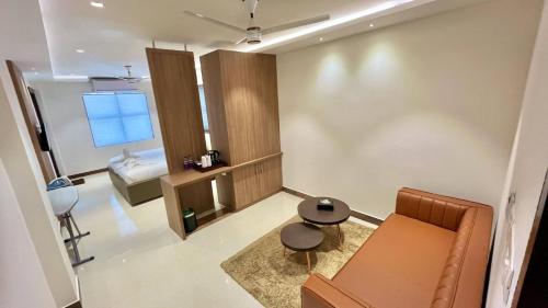 a small living room with a couch and a table at Hotel Pearl Palace in Cochin