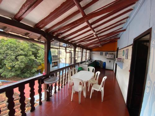 a balcony with a table and chairs on it at Casona Don Juan Hostel in San Gil