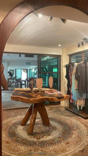 a wooden table in a room with a store at Hotel Rio Lagartos in Río Lagartos