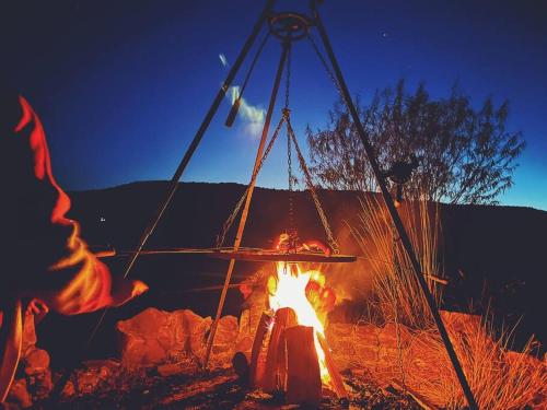 a fire pit with a person sitting around it at Polanka Beskid Niski cute cabin with spectacular views in Hańczowa