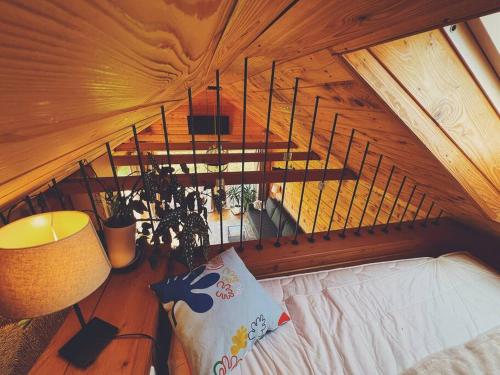 a room with a bed in a wooden ceiling at Polanka Beskid Niski cute cabin with spectacular views in Hańczowa