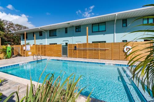 a swimming pool in front of a building at 400 South in Cocoa Beach