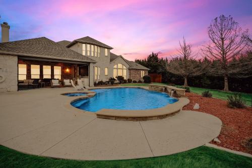 a swimming pool in the backyard of a house at Lakefront Mansion with Pool and Cinema in Rowlett