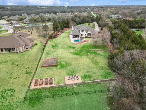 an aerial view of a large yard with a house at Lakefront Mansion with Pool and Cinema in Rowlett