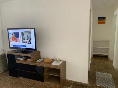 a television sitting on a table in a room at Casa na praia do centro in Marataizes