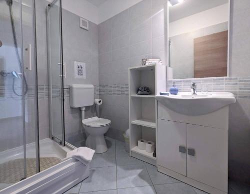 a bathroom with a sink and a toilet and a shower at Apartment Sea Garden in Ičići