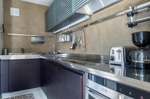 une cuisine avec un comptoir en acier inoxydable dans l'établissement Two bedroom apartment, Hypercenter, terrace Mont Blanc, parking, à Chamonix-Mont-Blanc