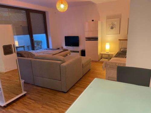 a living room with a couch and a refrigerator at Appartement Kirschblüte in Seehof