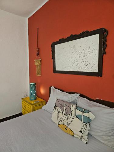 a bedroom with a bed with a painting on the wall at deux Studio avec patio a Sidi Bousaid in Dar Salah Bey