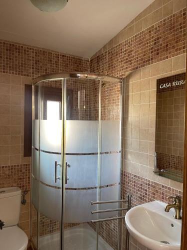 a bathroom with a shower and a toilet and a sink at Casa Rural Raíces del Alto Tajo in Armallones