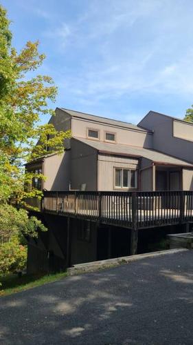 a house with a balcony on the side of it at Pocono Mountains Village at Camelback 284 Overlook Way in Tannersville