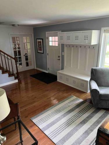 a living room with a couch and a chair at Cute Home near U of M and EMU in Ypsilanti