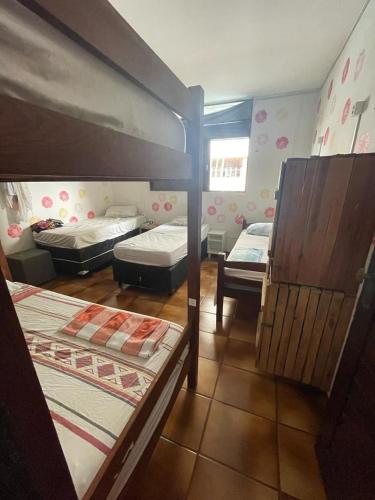 a room with two bunk beds and a window at Regiane Beach Pousada Hostel in João Pessoa