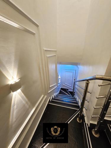 a staircase in a building with a blue light at 2 Bed Apartment 2 - Cosy Benin City Escape in Benin City