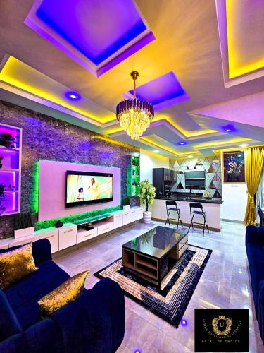 a living room with a couch and a tv at 2 Bed Apartment 8 - Modern Benin City Residence in Benin City