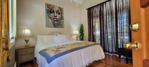 a bedroom with a bed and a window at Caye Caulker Boutique Guesthouse 6 in Caye Caulker