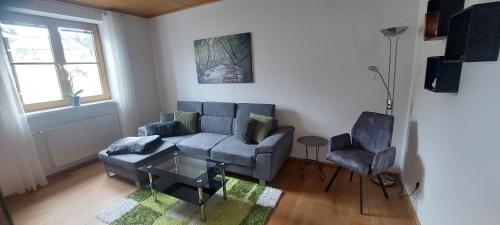 a living room with a couch and two chairs at Ferienwohnung Waldhäusl in Oberrosenauerwald