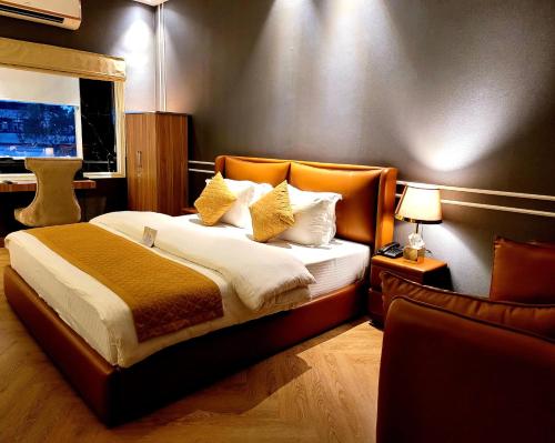 a bedroom with a bed with an orange headboard at Victorian Elegance Luxury Stays in Amritsar