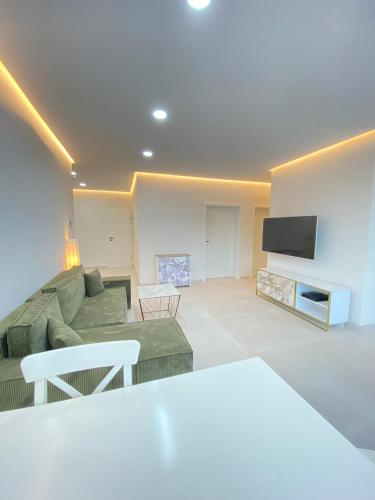 a living room with a couch and a tv at Apartment in Gaisbach close to Würth in Gaisbach