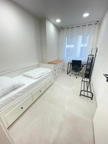 a bedroom with a bed and a desk and a chair at Apartment in Gaisbach close to Würth in Gaisbach