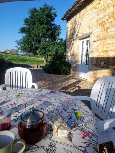 une table avec un pot assis au-dessus dans l'établissement Une Maison de campagne en Bourgogne du Sud, à Tournus
