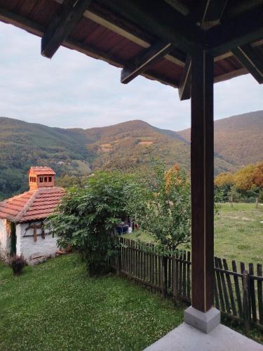 a view from the porch of a house with mountains in the background at Apartmani Ružina staza in Rudnik Kačerski