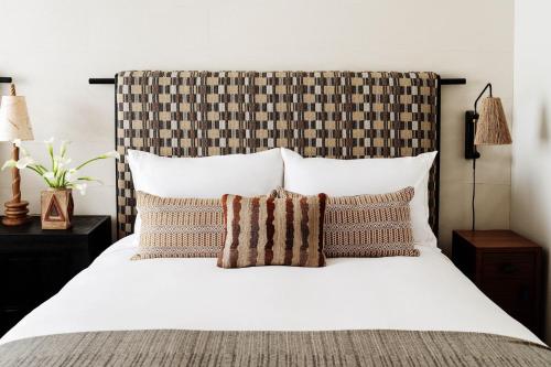 a bedroom with a large white bed with pillows at Downtown Los Angeles Proper Hotel, a Member of Design Hotels in Los Angeles