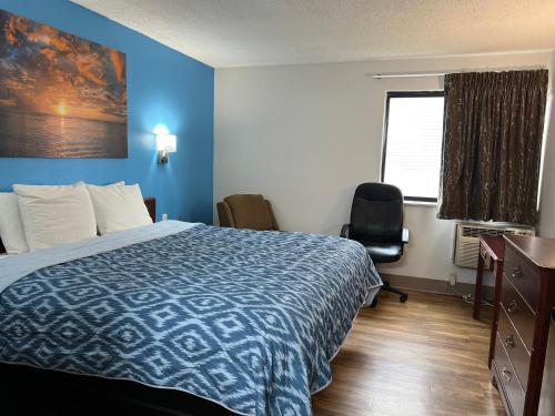 a hotel room with a bed and a desk and a window at Extended Stay Warrenton Inn in Warrenton