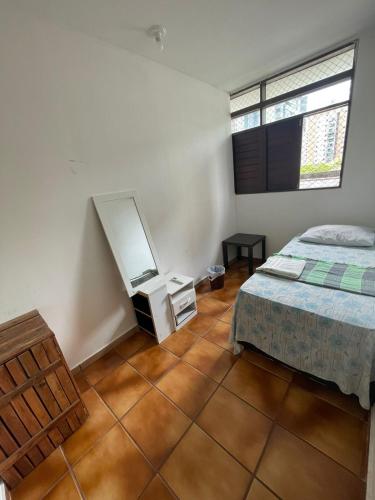 a bedroom with a bed and a dresser in it at Regiane Beach Pousada Hostel in João Pessoa