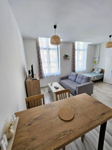 un salon avec une table et un canapé dans l'établissement Chez Home, à Valenciennes