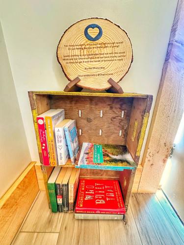 a book shelf with books and a basket on top at Brittany Motel in Sunderland