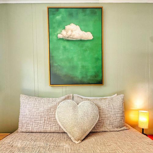 a heart pillow sitting on top of a bed at Brittany Motel in Sunderland