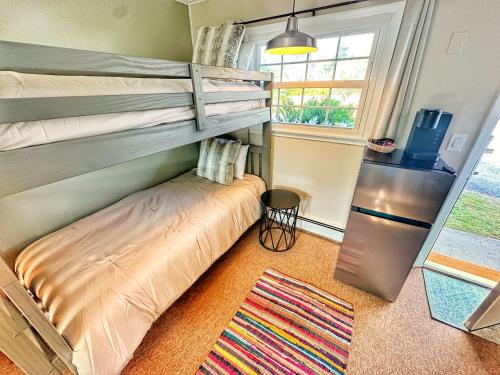 a bedroom with a bunk bed and a window at Brittany Motel in Sunderland